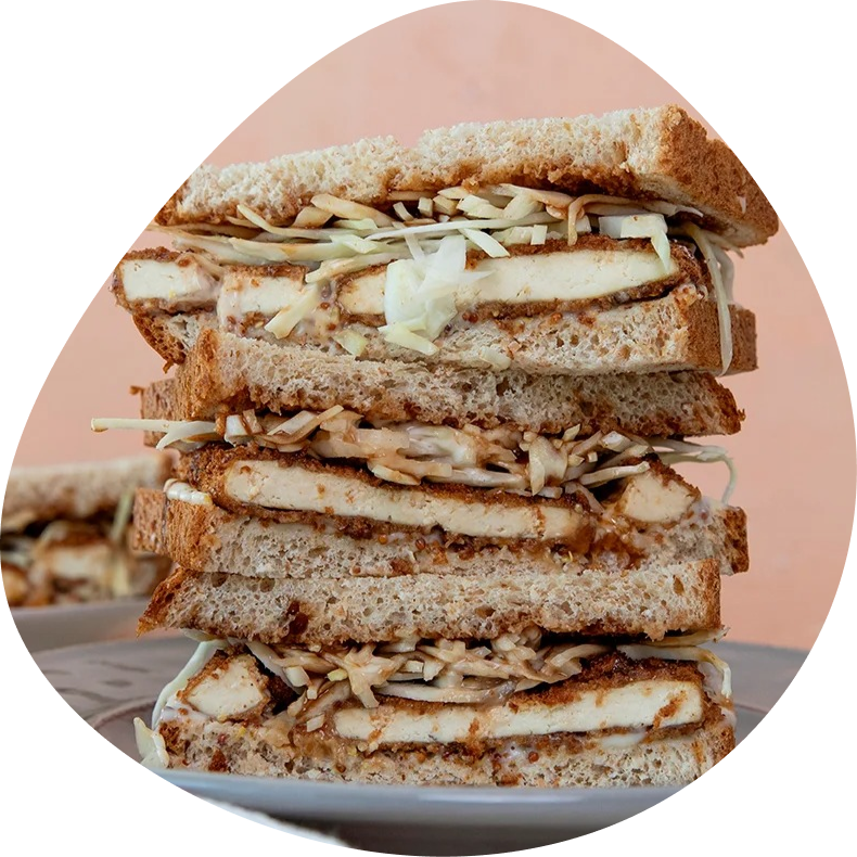 Stack of crispy tofu katsu sandwiches